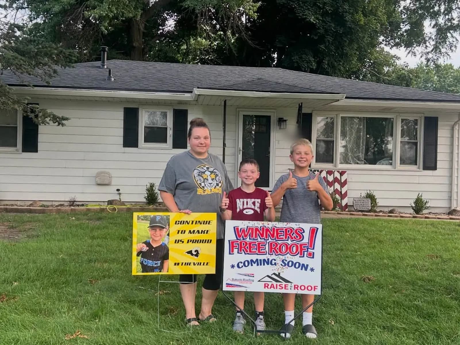 The Carr family standing in front of their home with the new Bakeris Roofing roof finished