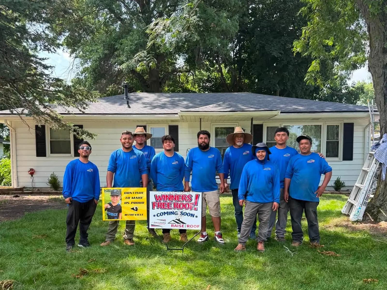 The Bakeris Roofing crew in front of the Carr family home after completing the new roof